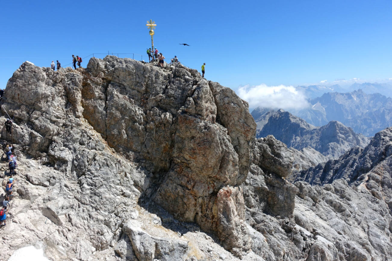 A golden cross marks the top of the 9,700-foot Zugspitze -- the highest point in Germany. The mountain straddles the border between Germany and Austria, and lifts from both countries whisk visitors to the top.