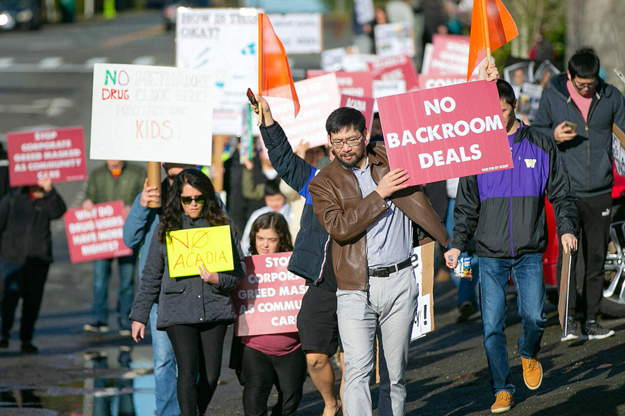 Demonstrators walk a short distance from a future methadone clinic to the Alderwood Boys & Girls Club during a protest against the clinic on Saturday, Jan. 14, 2023, in Lynnwood, Washington. (Ryan Berry / The Herald)