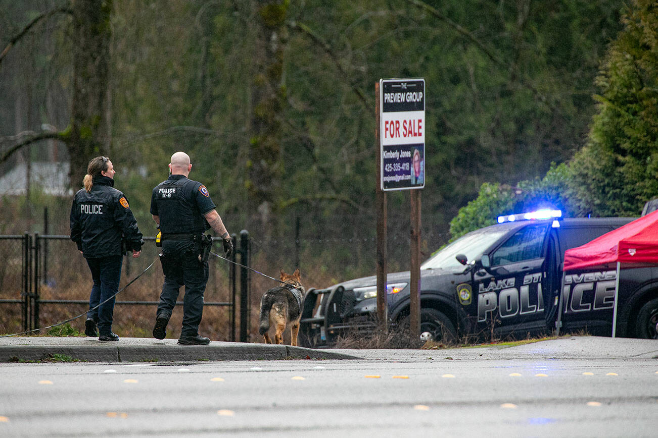 A police K-9 unit patrols the scene along 20th Street SE near Route 9 after a police-involved shooting left one person dead Friday, Jan. 13, 2023, in Lake Stevens, Washington. (Ryan Berry / The Herald)