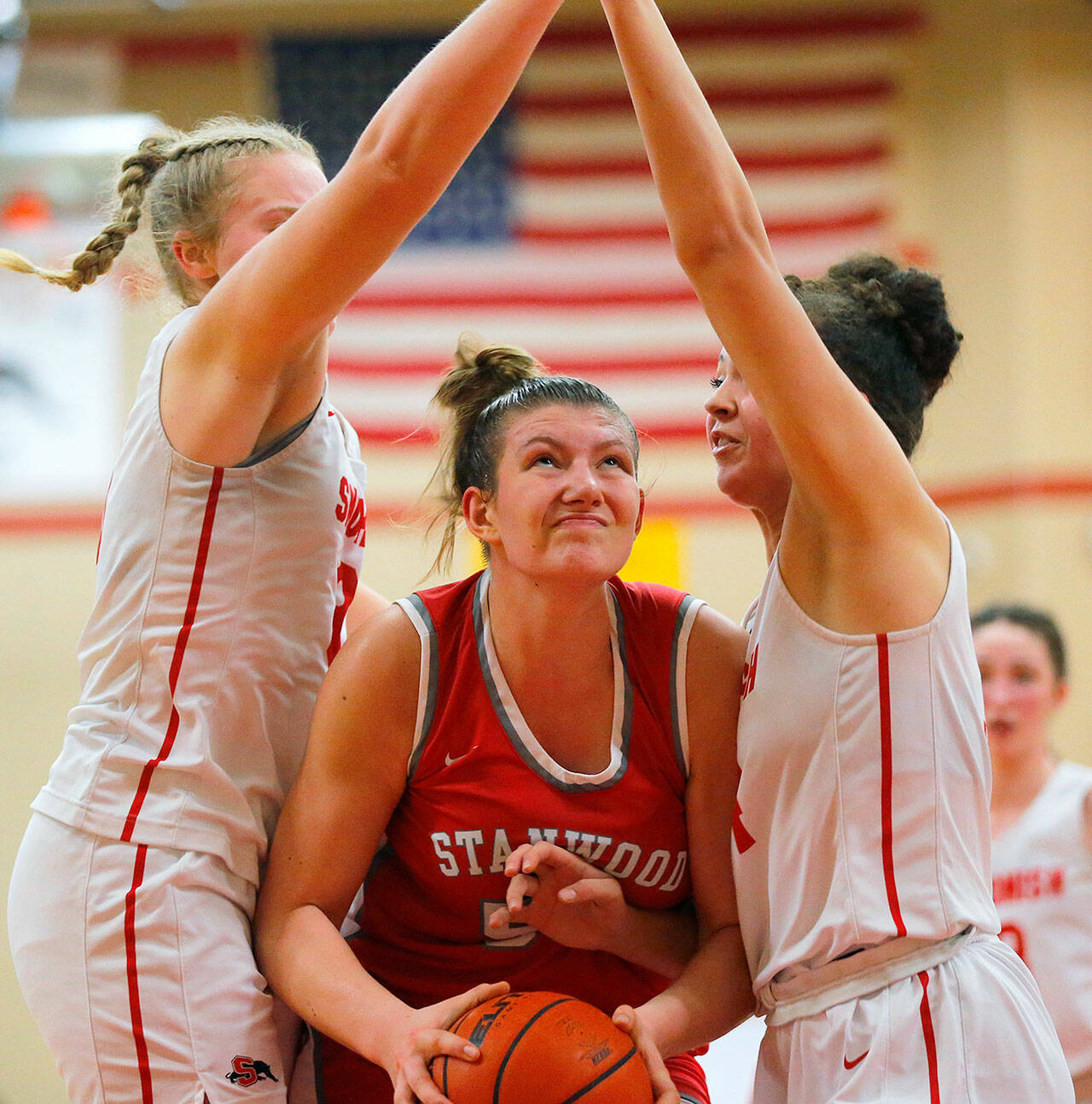 Stanwood’s Vivienne Berrett powers through two defenders for a close-range shot against Snohomish on Friday, Jan. 13, 2023, at Snohomish High School in Snohomish, Washington. (Ryan Berry / The Herald)