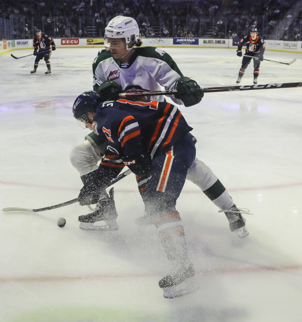 Kamloops’ Logan Stankoven (11) and Silvertips’ Eric Jamieson (5) fight for the puck during a game between the Silvertips and Kamloops Blazers at the Angel of the Winds Arena on Friday, Jan. 13, 2023. The Silvertips fell to the Kamloops, 3-6. (Annie Barker / The Herald)
