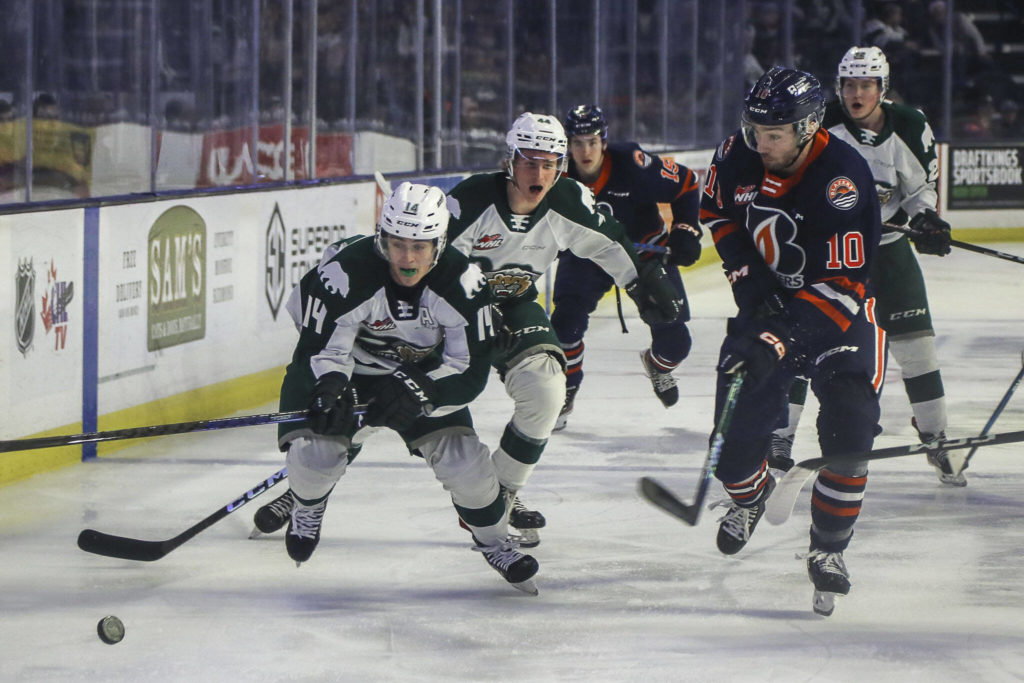 Silvertips’ Austin Roest (14) chases after the puck against Kamloops’ Ryan Hofer (10) during a game between the Silvertips and Kamloops Blazers at the Angel of the Winds Arena on Friday, Jan. 13, 2023. The Silvertips fell to the Kamloops, 3-6. (Annie Barker / The Herald)
