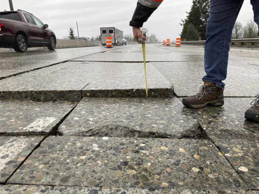 A measuring tape shows the height of the section of I-5 that rose and prompted two lanes to close, which led to major traffic backups in the area. (Courtesy of WSDOT)
