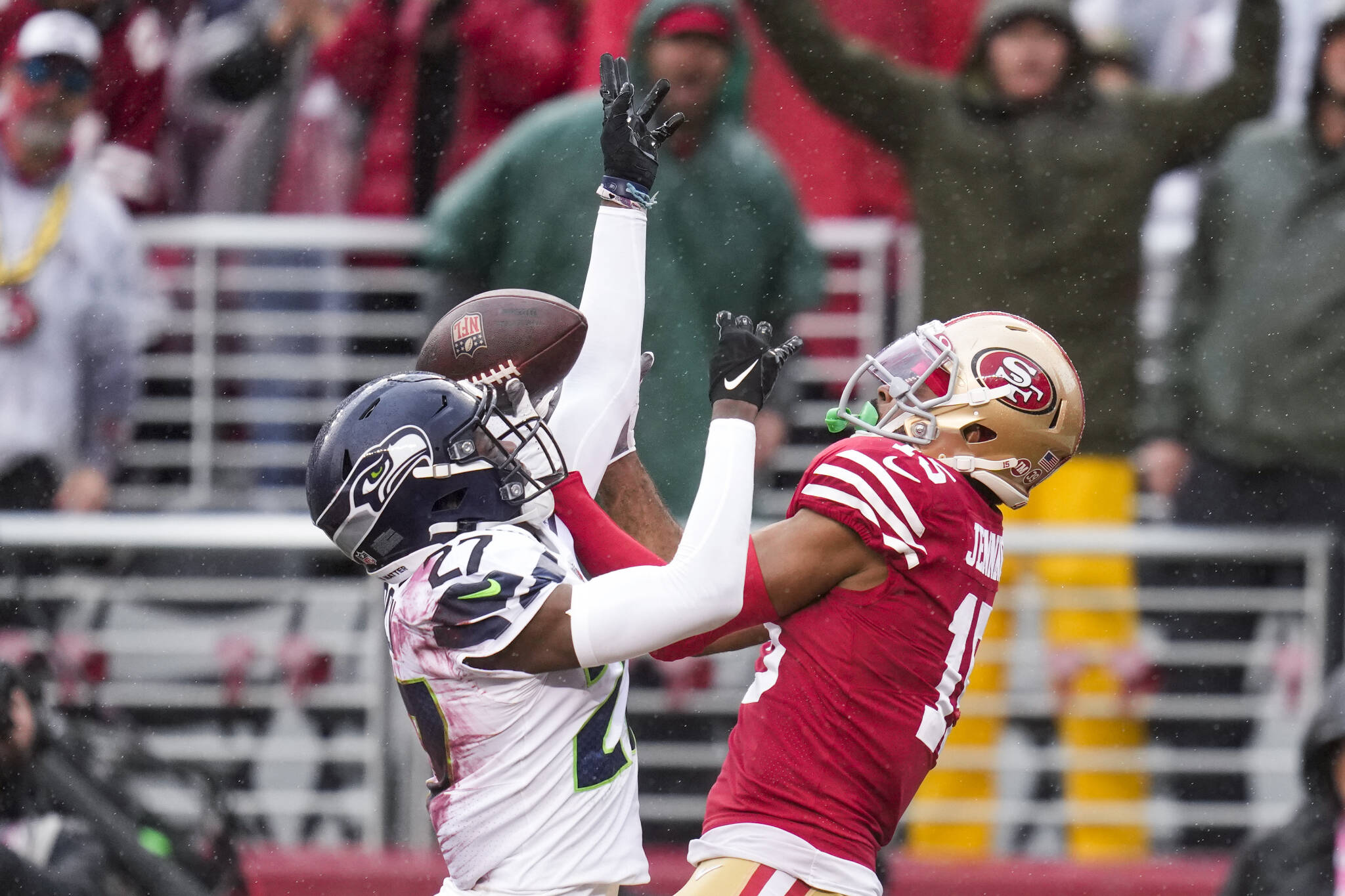 Seahawks cornerback Tariq Woolen (left) breaks up a pass intended for 49ers wide receiver Jauan Jennings during the first half of a playoff game Saturday in Santa Clara, Calif. (AP Photo/Godofredo A. Vásquez)