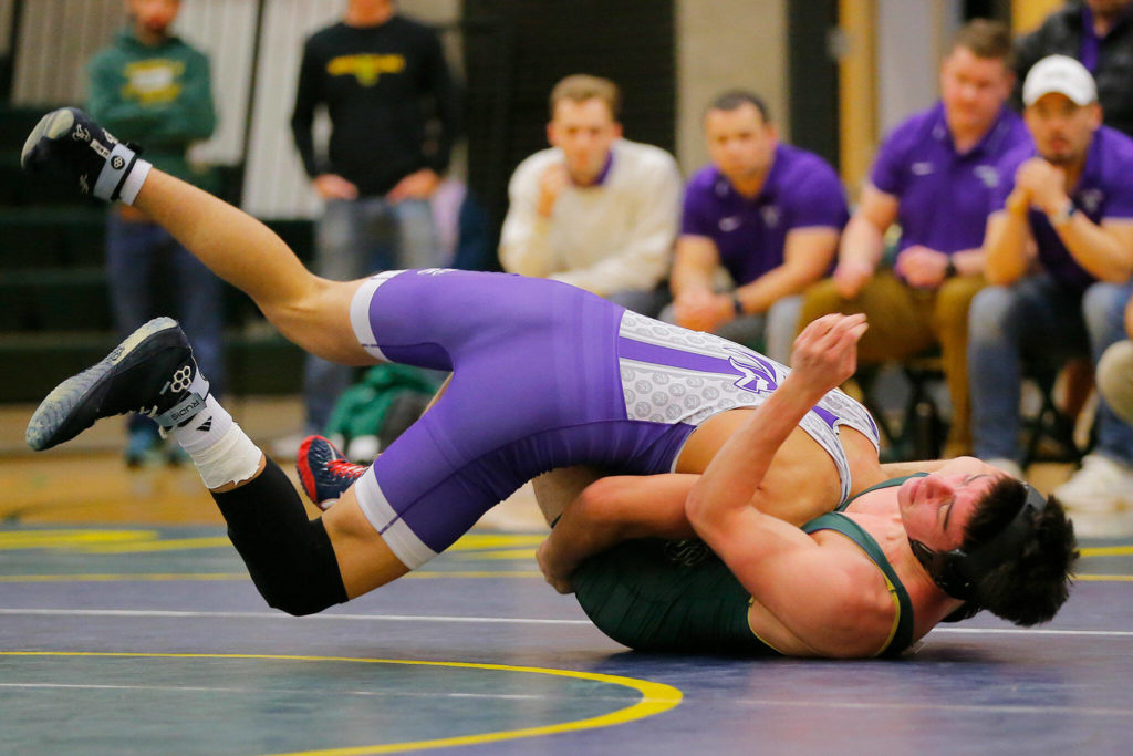 Edmonds-Woodway’s Ever Yamada takes down Shorecrest’s Max Rutledge on Wednesday, Jan. 18, 2023, at Shorecrest High School in Shoreline, Washington. (Ryan Berry / The Herald)
