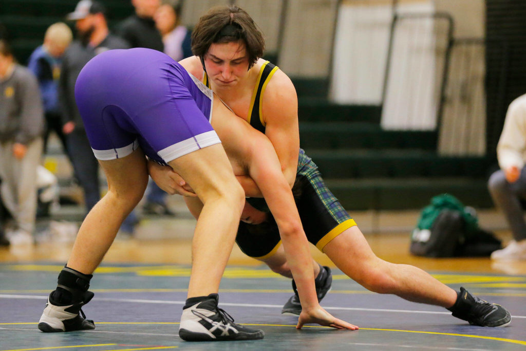 Shorecrest’s Carter Nichols tries to bring Edmonds-Woodway’s Reed Burmaster to the mat on Wednesday, Jan. 18, 2023, at Shorecrest High School in Shoreline, Washington. (Ryan Berry / The Herald)
