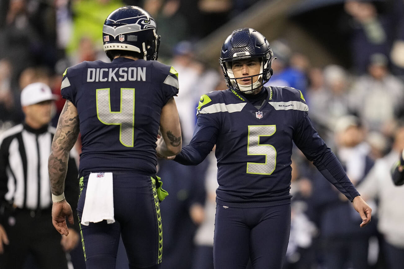Seattle Seahawks place kicker Jason Myers (5) shakes hands with place holder Michael Dickson (4) after Myers' game-winning field goal in overtime of an NFL football game against the Los Angeles Rams Sunday, Jan. 8, 2023, in Seattle. (AP Photo/Abbie Parr)