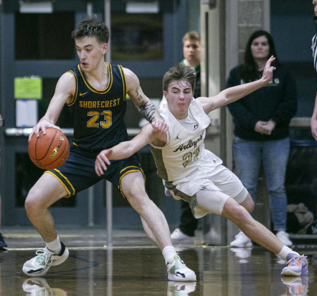 Arlington’s Leyton Martin tries to steal the ball from Shorecrest’s Parker Baumann during the game on Thursday, Jan. 19, 2023 in Arlington, Washington. (Olivia Vanni / The Herald)
