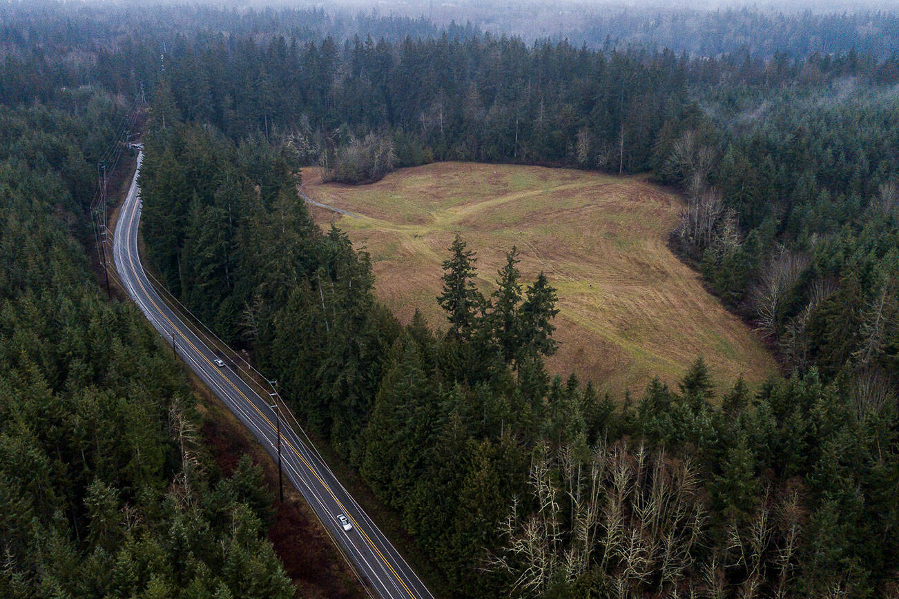 Cars move along Frank Waters Road next to a contaminated land site purchased by Robinett Brothers on Tuesday, Jan. 24, 2023 in Stanwood, Washington. (Olivia Vanni / The Herald)