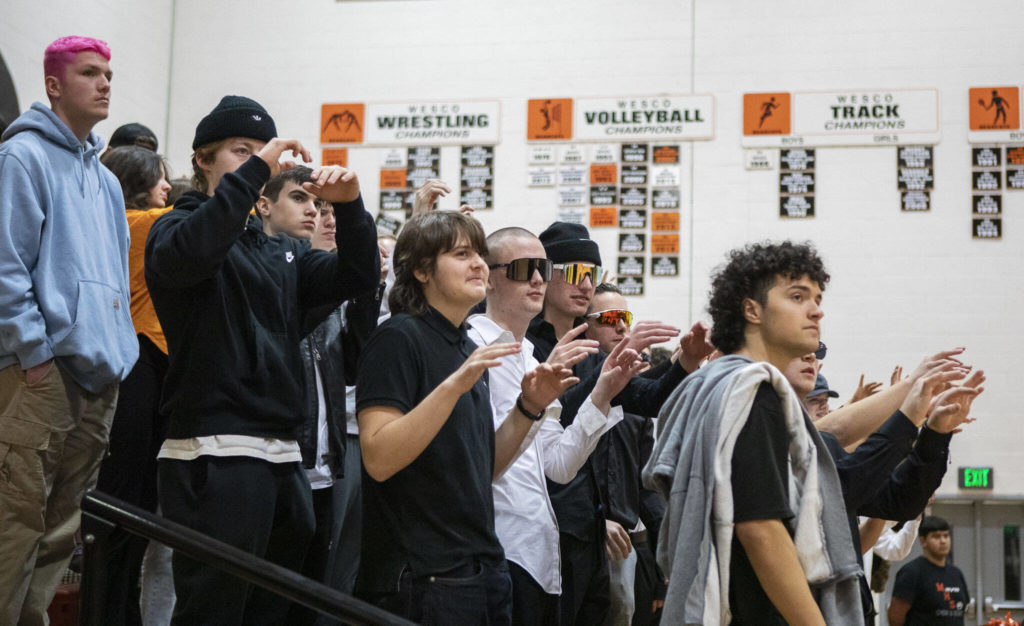Monroe students wiggle their fingers for good luck during a free-throw during a game between the Monroe Bearcats and the Edmonds-Woodway Warriors at Monroe High School in Monroe, on Jan. 20. The Bearcats defeated the Warriors, 68-57. (Annie Barker / The Herald) 
