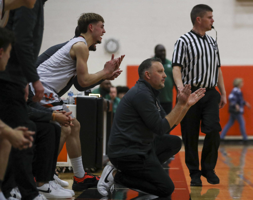 Monroe’s Steve Kuhnle (1) left, and head coach Justin Prohn, right, cheer and yell during a game between the Monroe Bearcats and the Edmonds-Woodway Warriors at Monroe High School in Monroe on Jan. 20. The Bearcats defeated the Warriors, 68-57. (Annie Barker / The Herald)
