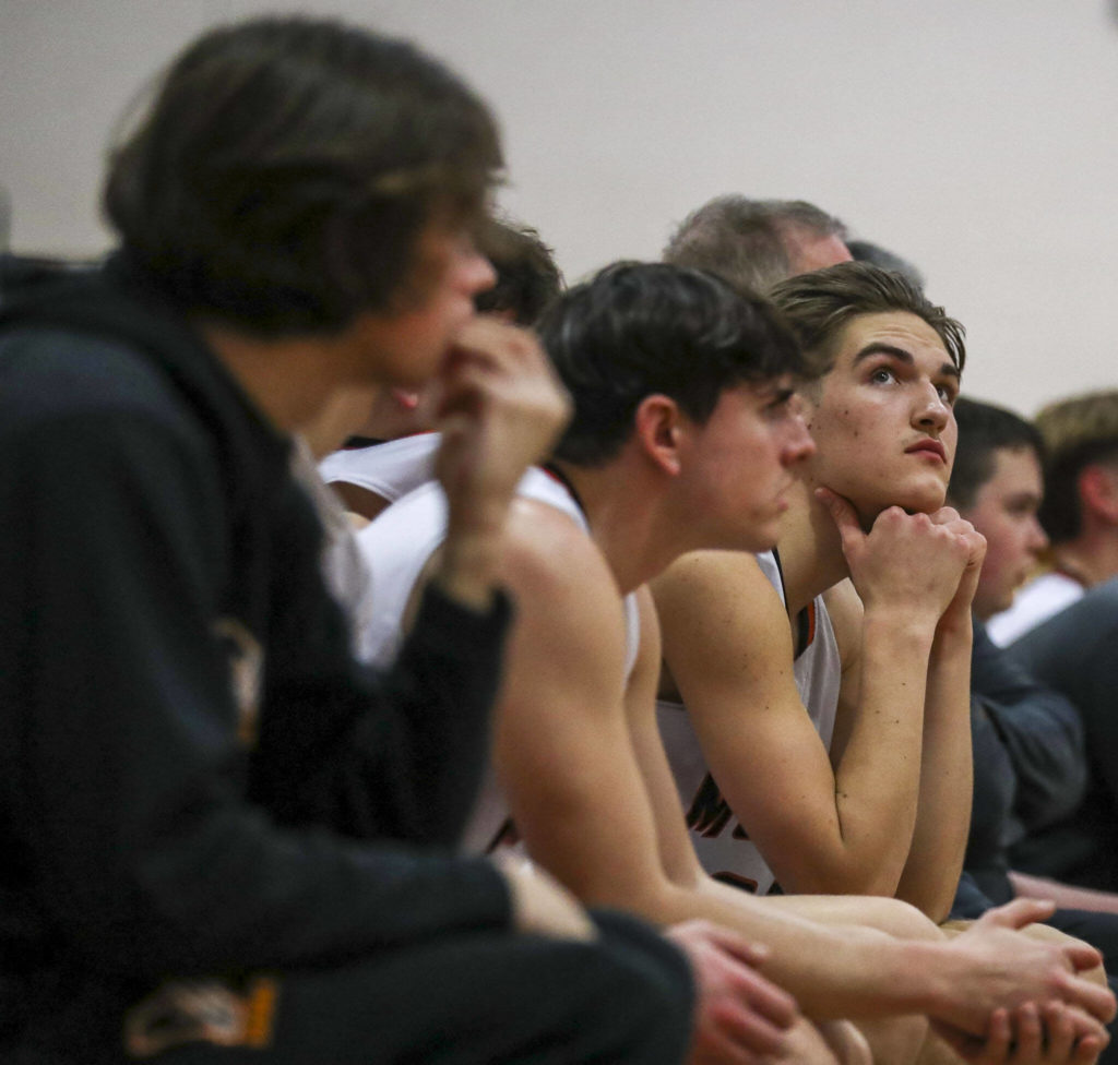 A Monroe player checks the scoreboard during a game between the Monroe Bearcats and the Edmonds-Woodway Warriors at Monroe High School in Monroe, on Jan. 20. The Bearcats defeated the Warriors, 68-57. (Annie Barker / The Herald)
