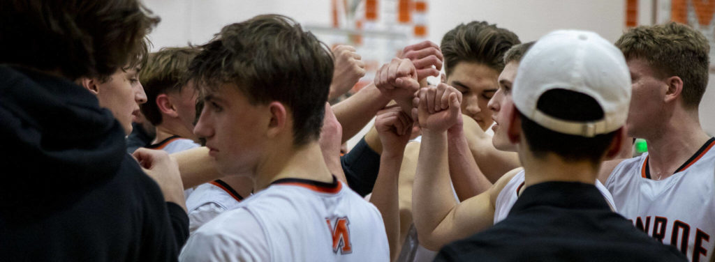 Monroe players fist-bump during a game between the Monroe Bearcats and the Edmonds-Woodway Warriors at Monroe High School in Monroe, on Jan. 20. The Bearcats defeated the Warriors, 68-57. (Annie Barker / The Herald)
