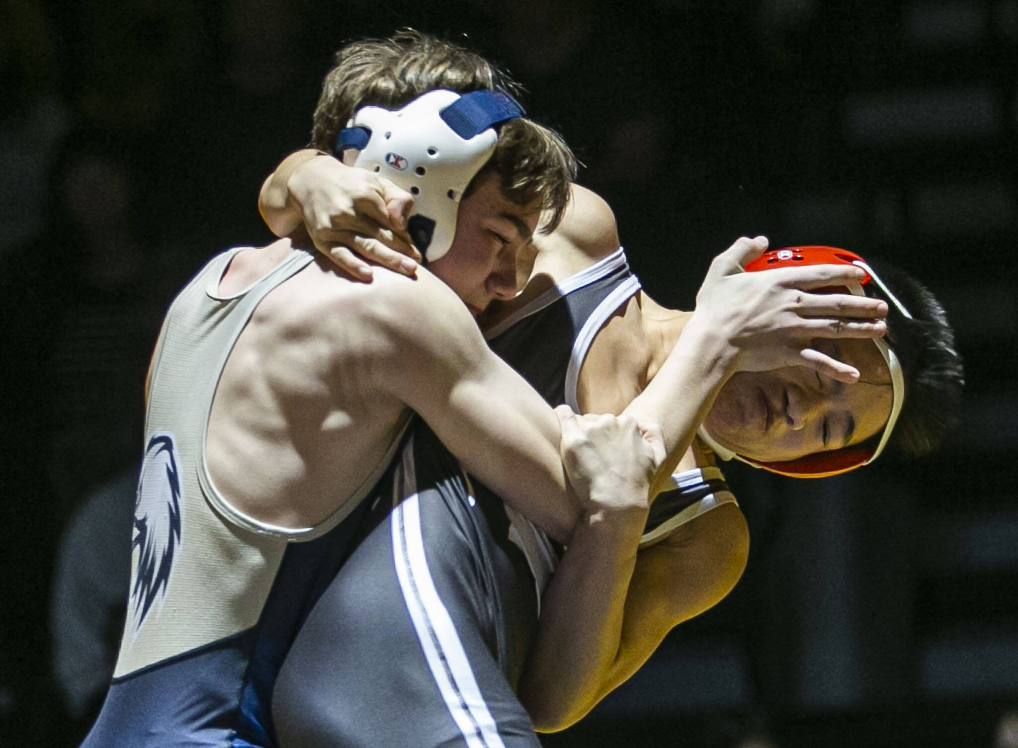 Stanwood’s Marc Hruschka gets his face pushed by Arlington’s Mason Boardley during the 106 pound weigh class match on Tuesday, Jan. 24, 2023 in Arlington, Washington. (Olivia Vanni / The Herald)