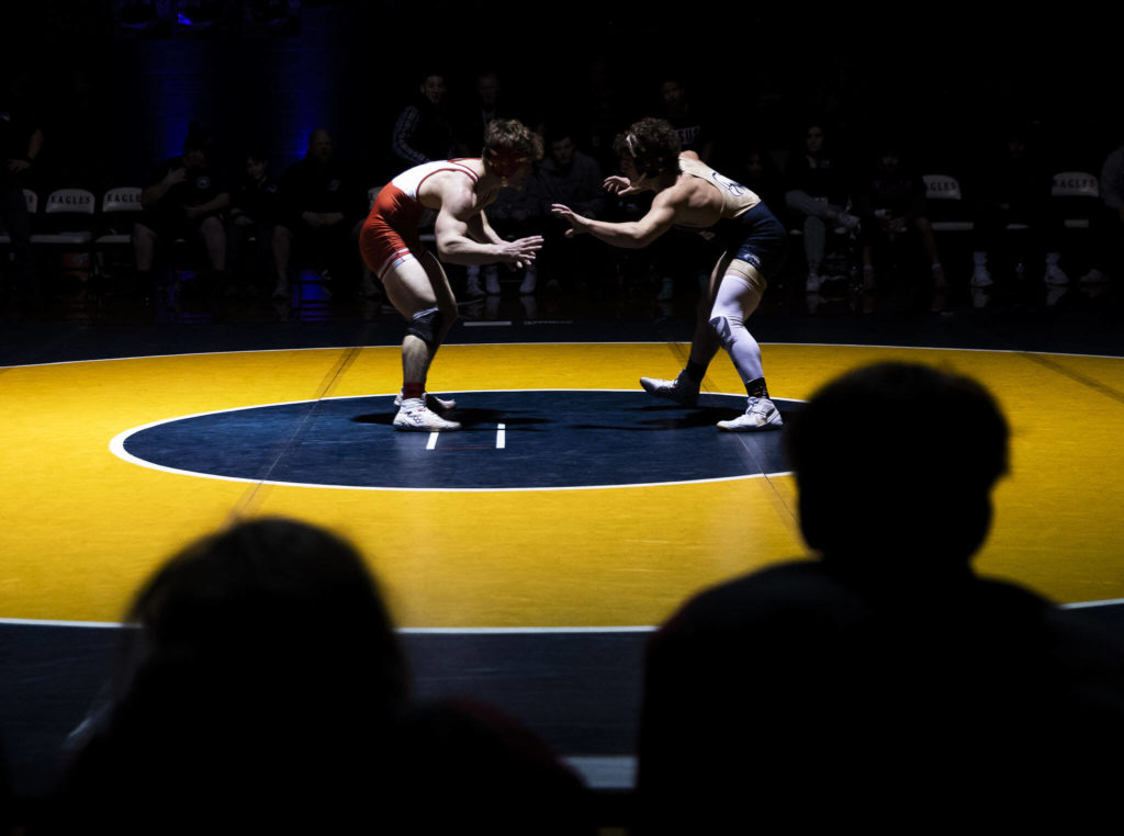 Arlington’s Dustin Baxter and Stanwood’s Ryder Bumgarner wrestle during the 170 pound weight class match on Tuesday, Jan. 24, 2023 in Arlington, Washington. (Olivia Vanni / The Herald)

