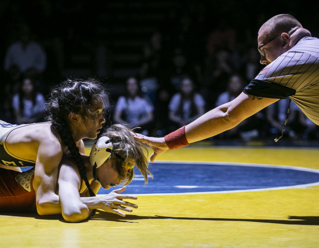 Arlington AJ Dorchak looks up at the referee while wrestling Stanwood’s Soren Andersen during the 113 pound weight class match on Tuesday, Jan. 24, 2023 in Arlington, Washington. (Olivia Vanni / The Herald)
