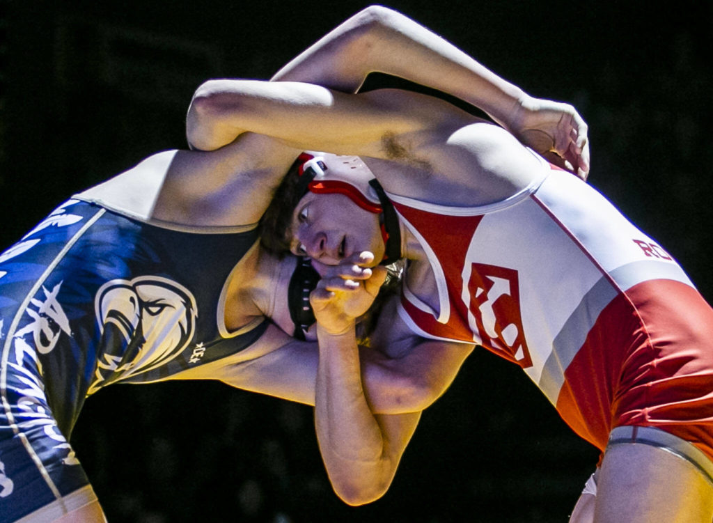 Arlington’s Beau Gudde and Stanwood’s Bryan Roodzant lock arms during the 126 pound weight class match on Tuesday, Jan. 24, 2023 in Arlington, Washington. (Olivia Vanni / The Herald)

