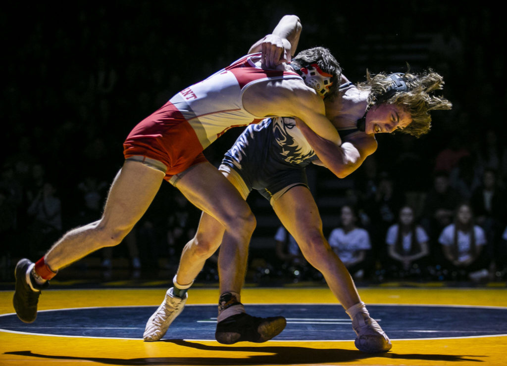 Arlington’s Beau Gudde tries to throw Stanwood’s Bryan Roodzant during the 126 pound weight class match on Tuesday, Jan. 24, 2023 in Arlington, Washington. (Olivia Vanni / The Herald)
