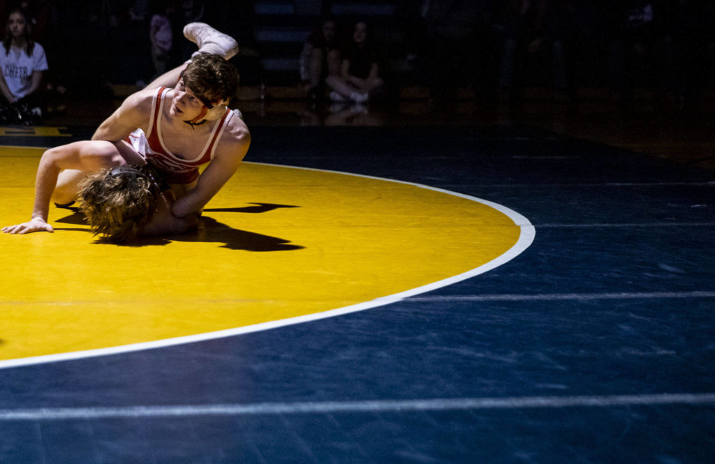 Stanwood’s Bryan Roodzant looks up to his coach the during the 126 pound weight class match on Tuesday, Jan. 24, 2023 in Arlington, Washington. (Olivia Vanni / The Herald)
