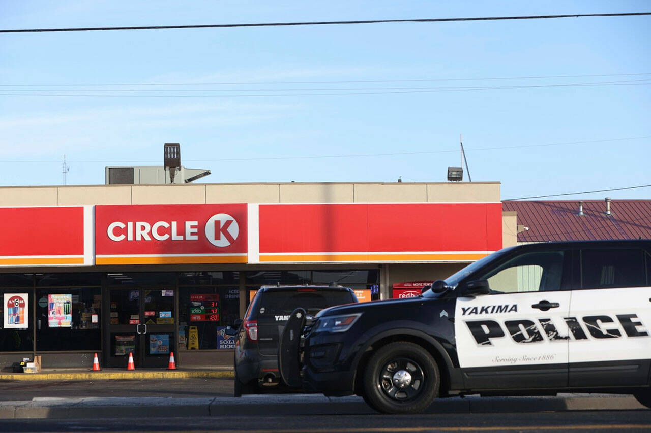 Police cordon off the area around a Circle K convenience store on Nob Hill Boulevard in Yakima, on Tuesday, where people were fatally shot in the early morning. (Emree Weaver / Yakima Herald-Republic via AP)