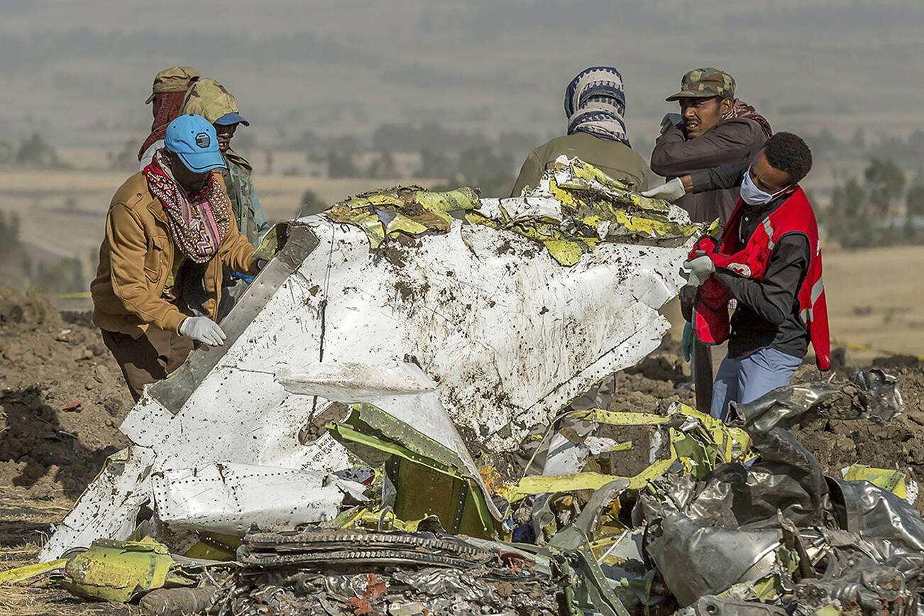 FILE - In this file photo dated Monday, March 11, 2019, rescuers work at the scene of an Ethiopian Airlines plane crash south of Addis Ababa, Ethiopia.  The number of deaths in major air crashes around the globe fell by more than half in 2019 according to a report released Wednesday Jan. 1, 2020, by the aviation consultancy To70, revealing the worst crash for the year was an Ethiopian Airlines Boeing 737 MAX on March 10 that lost 157 lives. (AP Photo/Mulugeta Ayene, FILE)