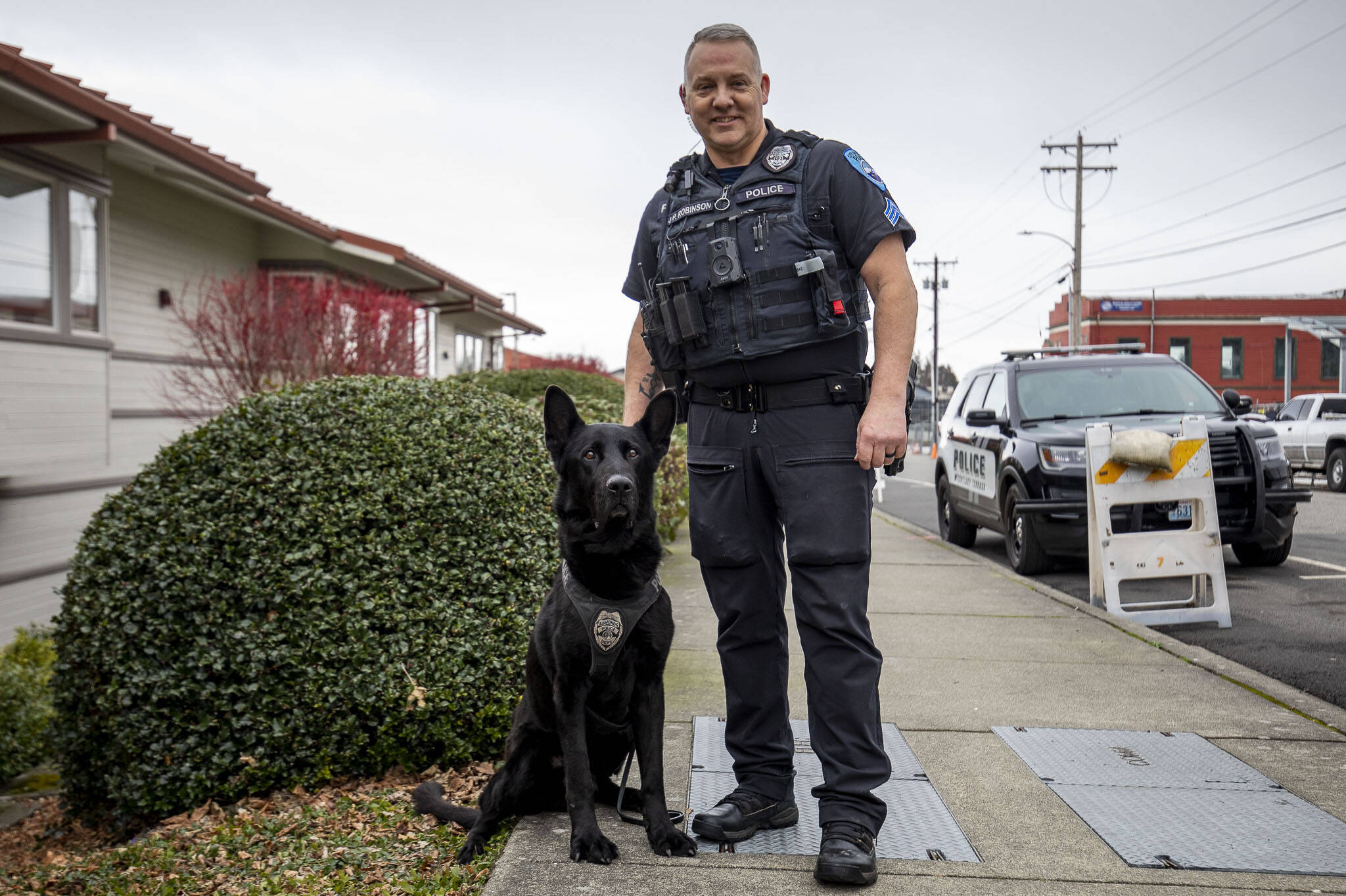 K-9 Hobbs and Sgt. Jason Robinson after Hobbs’ retirement ceremony at the Edmonds Police Department on Thursday in Edmonds. (Annie Barker / The Herald)