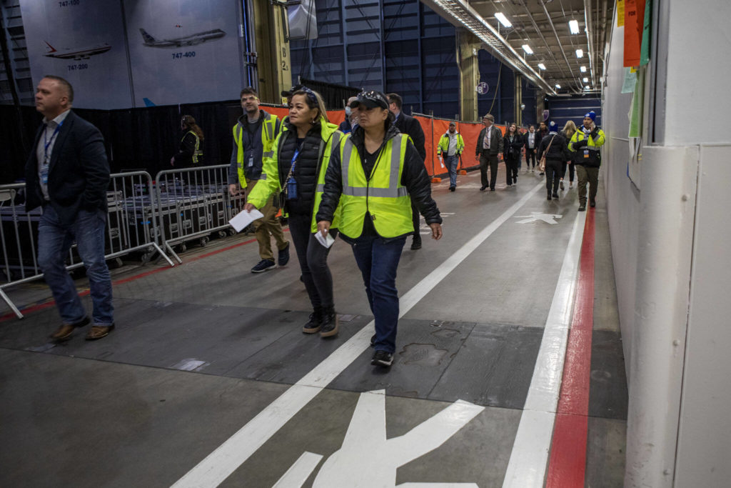 People enter a celebration on Tuesday, at the 747 factory in Everett. (Annie Barker / The Herald)
