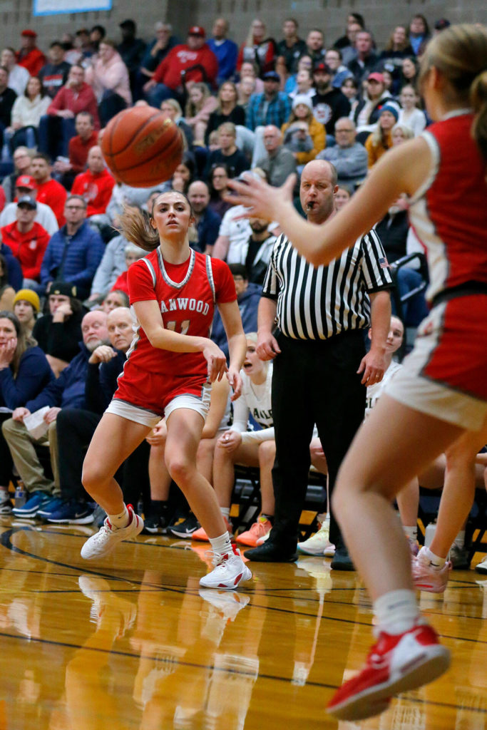 Stanwood’s Tatum Brager passes down low to EllaLee Wortham for an assist against Arlington on Wednesday, Jan. 25, 2023, at Arlington High School in Arlington, Washington. (Ryan Berry / The Herald)
