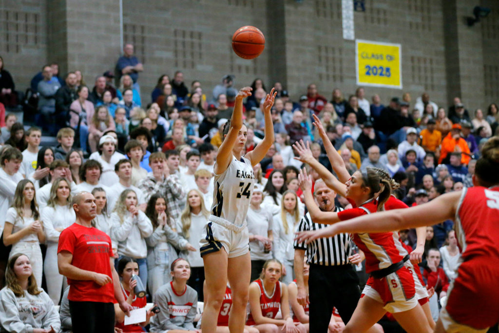 Arlington’s Jenna Villa shoots a three early in the game against Stanwood on Wednesday, Jan. 25, 2023, at Arlington High School in Arlington, Washington. (Ryan Berry / The Herald)
