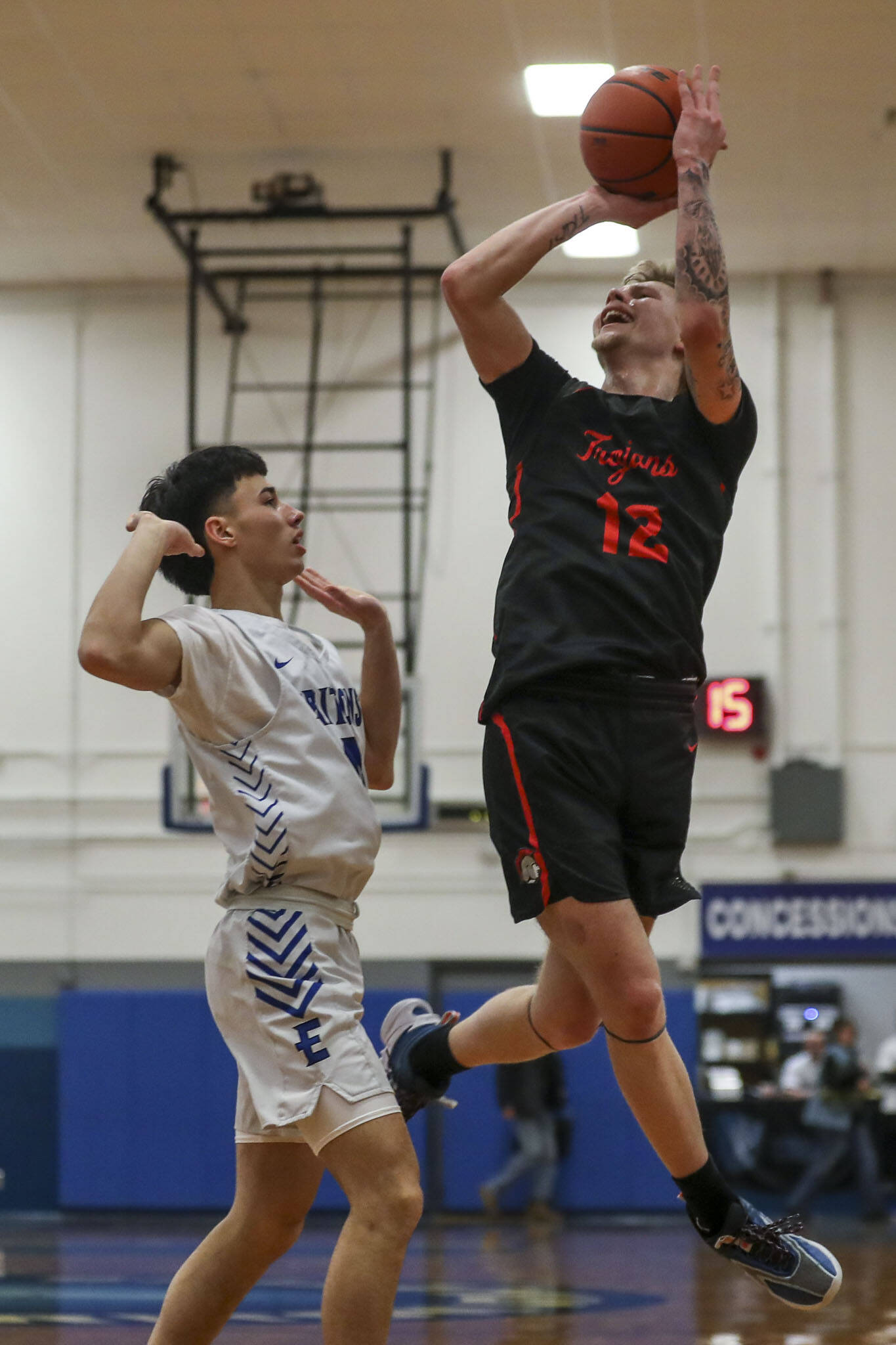 ECC’s Colton Spencer (12) shoots the ball during a men’s game between the Everett Community College Trojans and Edmonds College Tritons at Seaview Gymnasium at Edmonds College in Lynnwood, Washington on Wednesday Jan. 25, 2023. The Tritons won, 91-84. (Annie Barker / The Herald)