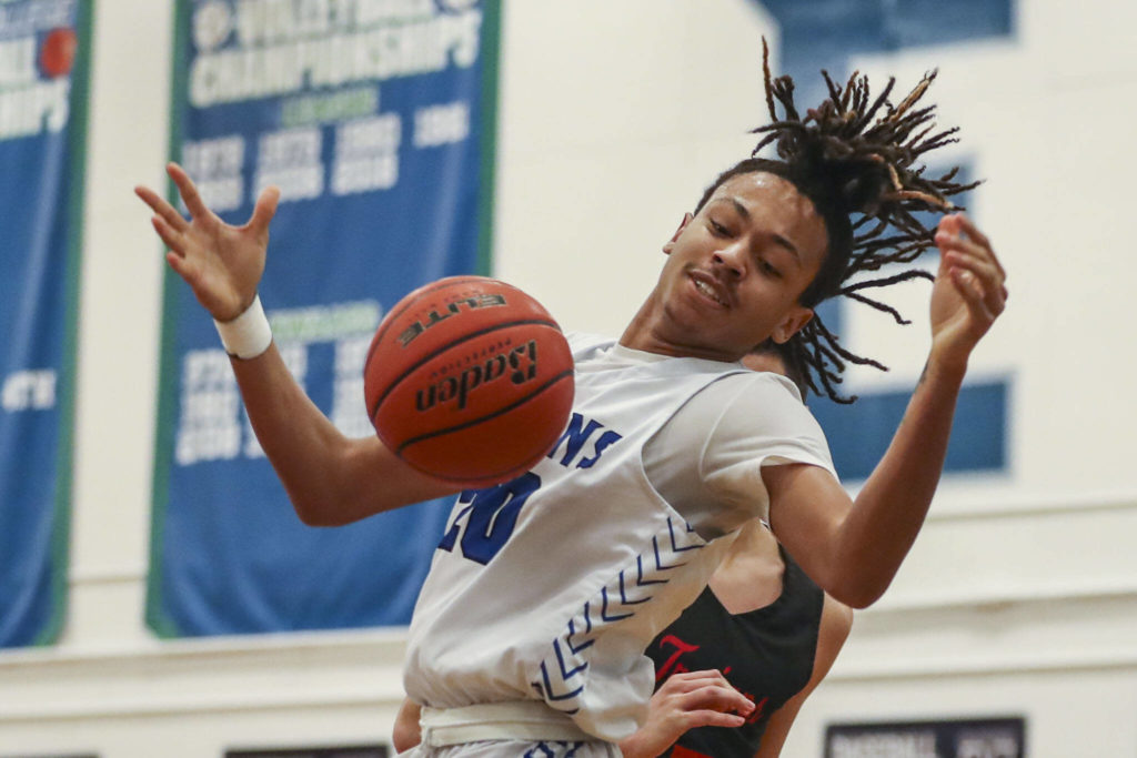 EC’s Damajio Merritt (20) fights for the ball during a men’s game between the Everett Community College Trojans and Edmonds College Tritons at Seaview Gymnasium at Edmonds College in Lynnwood, Washington on Wednesday Jan. 25, 2023. The Tritons won, 91-84. (Annie Barker / The Herald)
