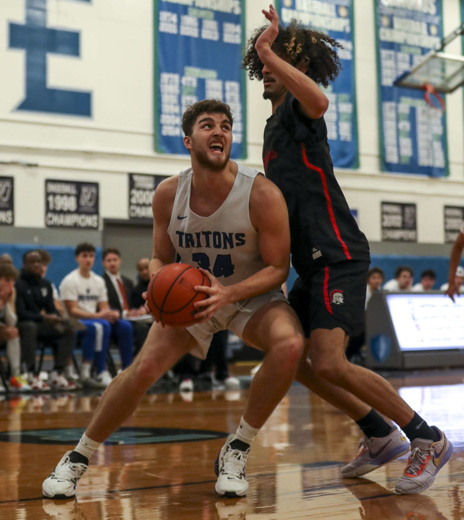 ECC’s Elyon Zevenbergen (34) shoots the ball during a men’s game between the Everett Community College Trojans and Edmonds College Tritons at Seaview Gymnasium at Edmonds College in Lynnwood, Washington on Wednesday Jan. 25, 2023. The Tritons won, 91-84. (Annie Barker / The Herald)
