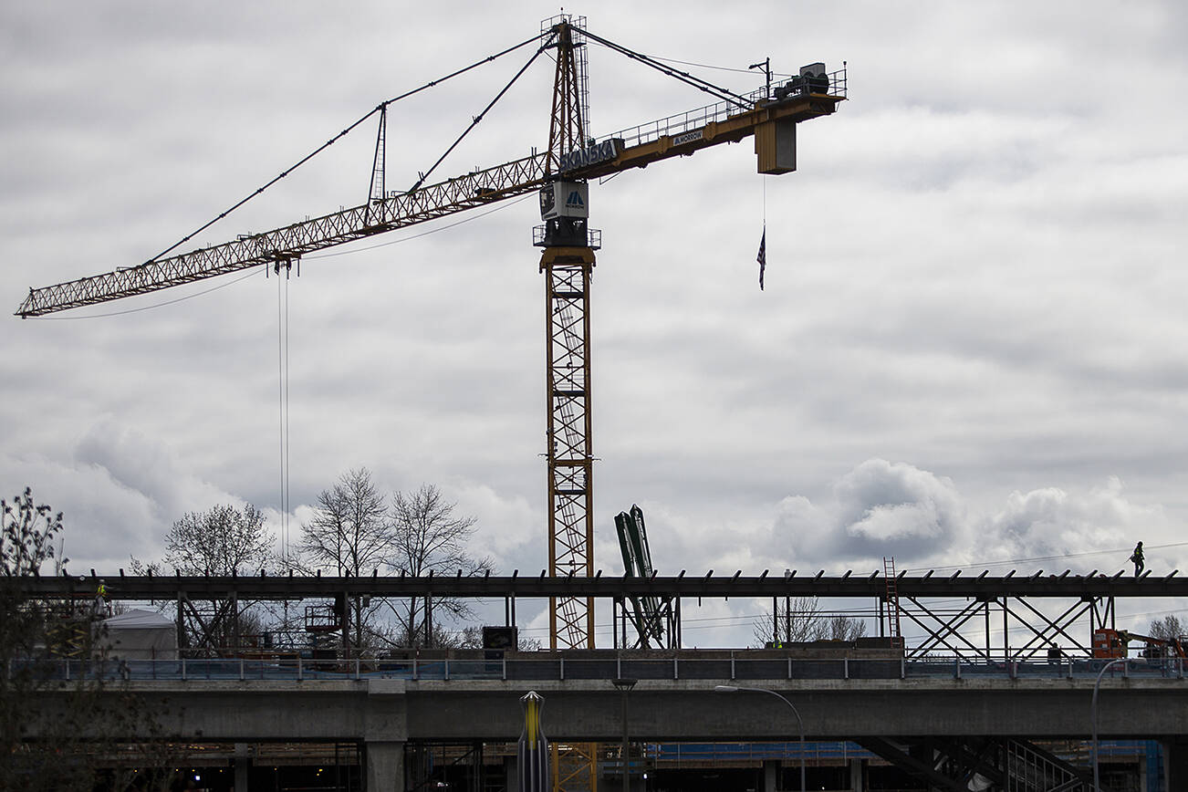 Construction crews work on the Lynnwood Light rail station on Tuesday, March 29, 2022 in Lynnwood, Washington. (Olivia Vanni / The Herald)