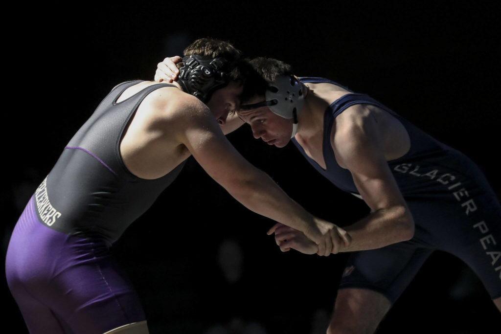 Lake Stevens’ Lucas Overland and Glacier Peak’s Angus van Valey wrestle during the 195 pound weight class match at Lake Stevens High School on Thursday Jan. 26, 2023. (Annie Barker / The Herald)
