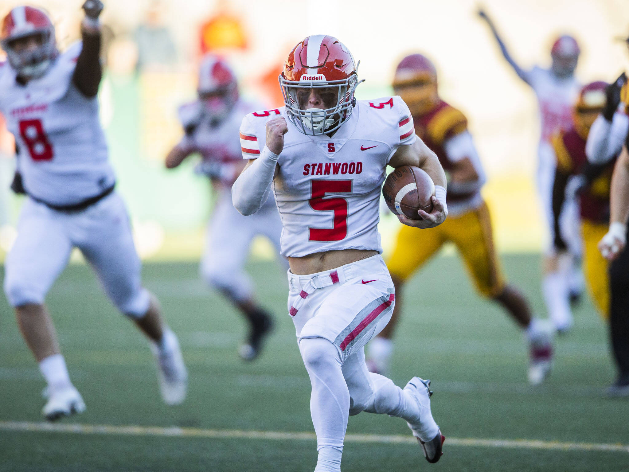 Stanwood running back Ryder Bumgarner breaks away for a touchdown during 3A state quarterfinal game against O’Dea on Nov. 19, 2022 in Seattle. (Olivia Vanni / The Herald)