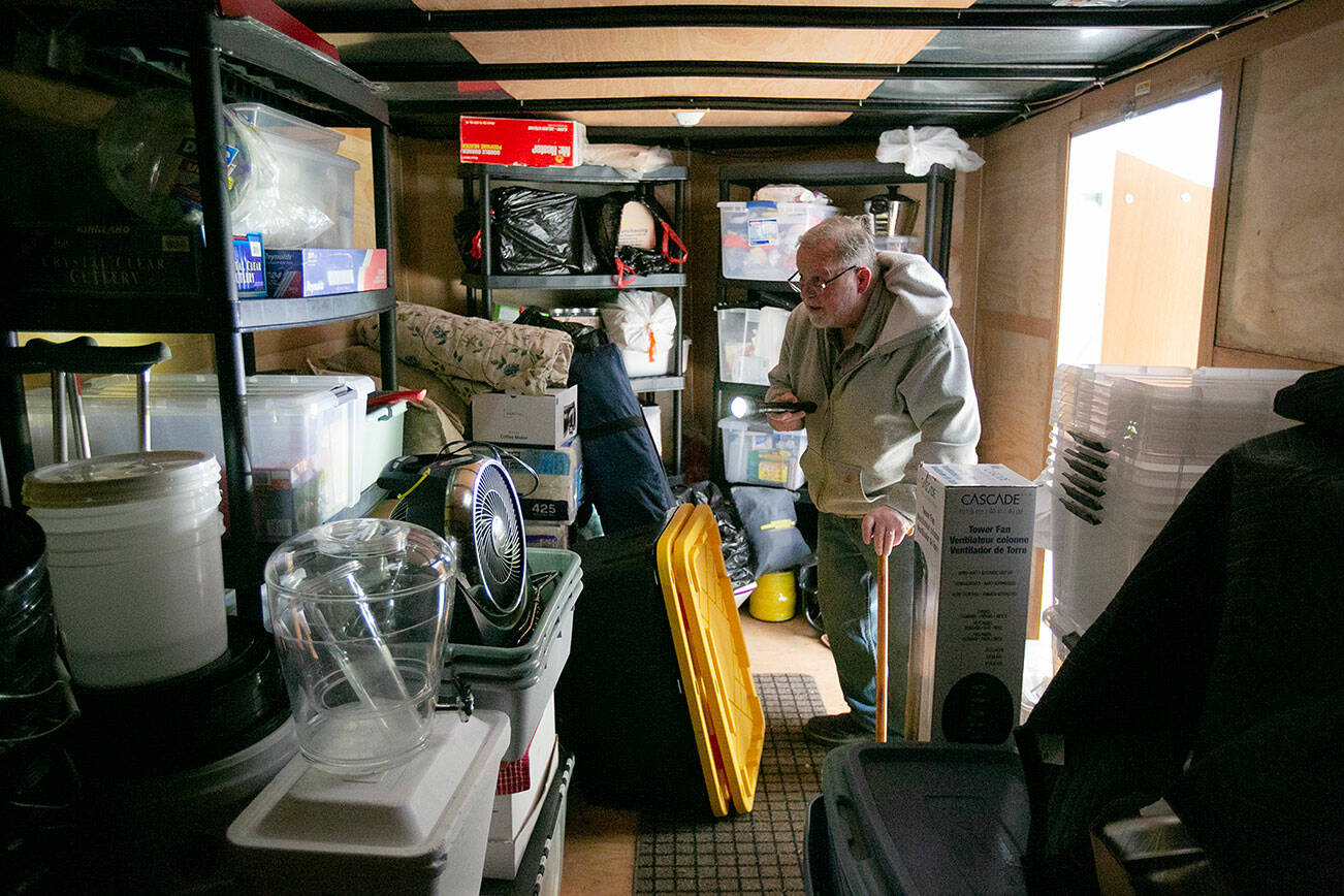 Ron Thompson looks around inside a trailer that he and his wife Gail keep stocked with emergency supplies in case of emergency at their home Thursday, Feb. 2, 2023, in Oso, Washington. The Thompsons lost their home to the 2014 slide that claimed dozens of lives, and in the years since, they have worked to prepare themselves and their community members for future disaster. (Ryan Berry / The Herald)