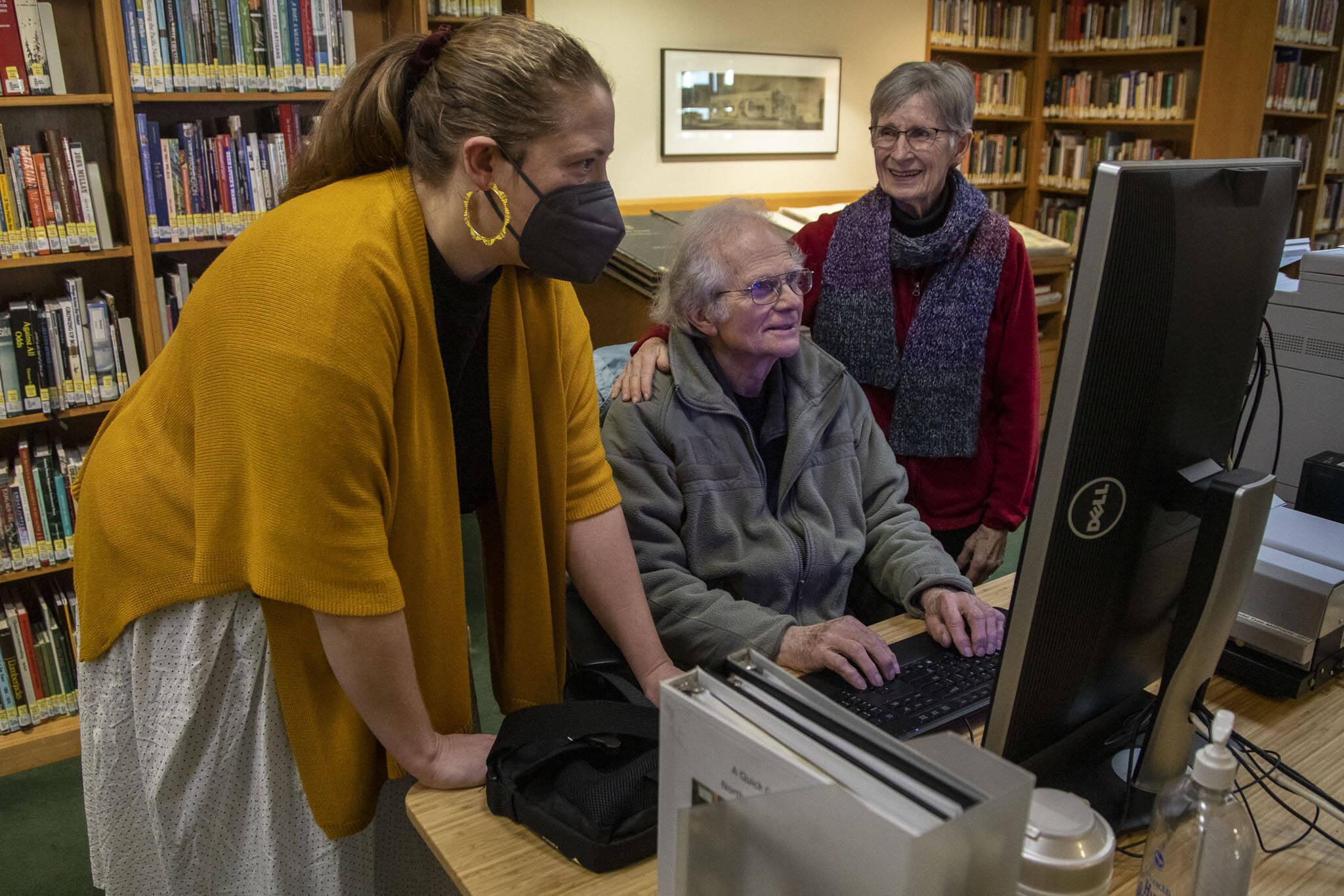 Left to right, Northwest Room Librarian Lisa Labovitch, 41, and contributors to HistoryLink, an online encyclopedia on Washington history, David Cameron, 81, and Louise Lindgren, 79, pose for a photo on Jan. 19, at the Everett Public Library. (Annie Barker / The Herald)