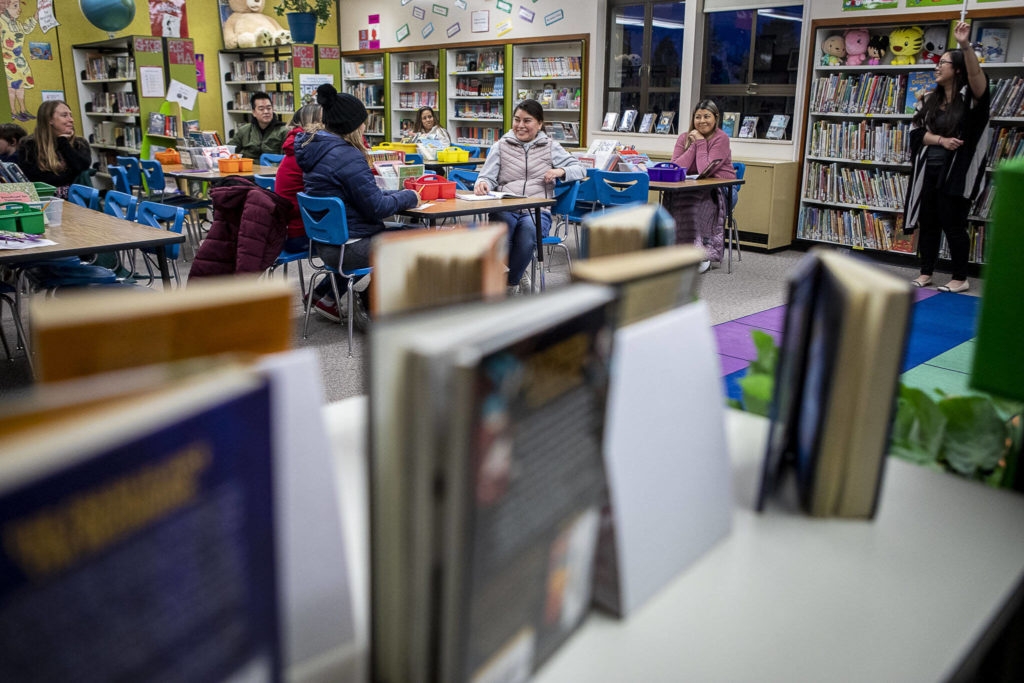 Maricel Pe Samaniego, right, teaches English at Liberty Elementary School on Jan. 30, in Marysville. Marysville schools partners with EvCC to offer free English classes to parents of multi-lingual students. (Annie Barker / The Herald)
