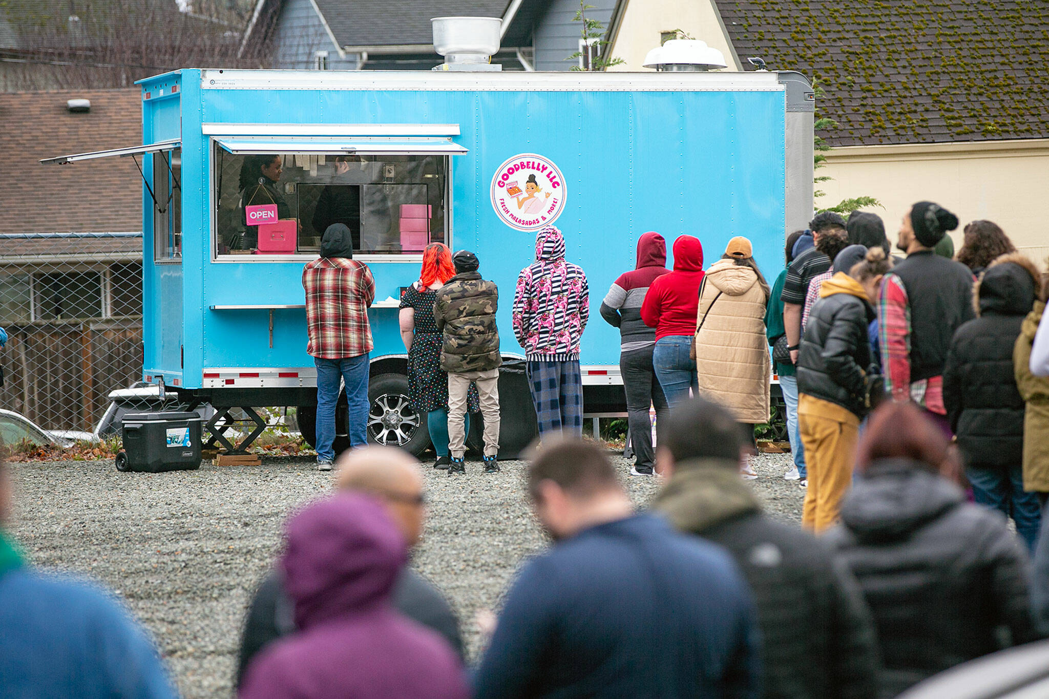 Nearly 100 people wait to place their orders at Alice Tum’s food trailer on its opening day Jan. 28 in Everett. (Ryan Berry / The Herald)