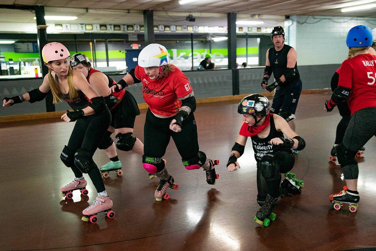 "Rose Misconduct" Ciara Jay, wearing a star helmet, plays as the jammer and tries to pass blockers on the other team during a Strawberry City Roller Derby practice at Marysville Skate Center on Monday, Feb. 6, 2023, in Marysville, Washington. (Ryan Berry / The Herald)