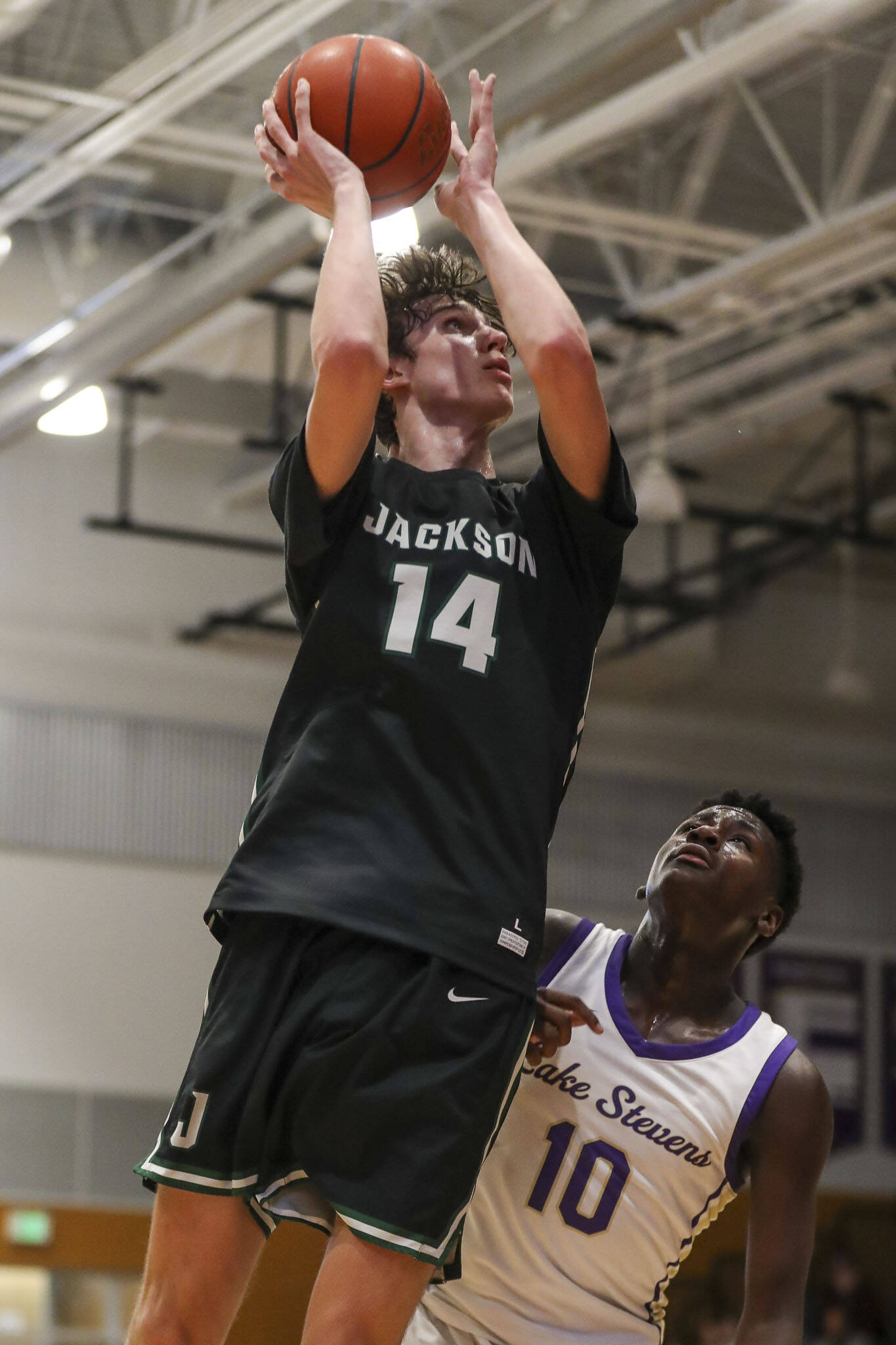 Jackson’s Ryan Mcferran (14) shoots the ball during a game against Lake Stevens on Tuesday in Lake Stevens. Jackson won 87-69. (Annie Barker / The Herald)