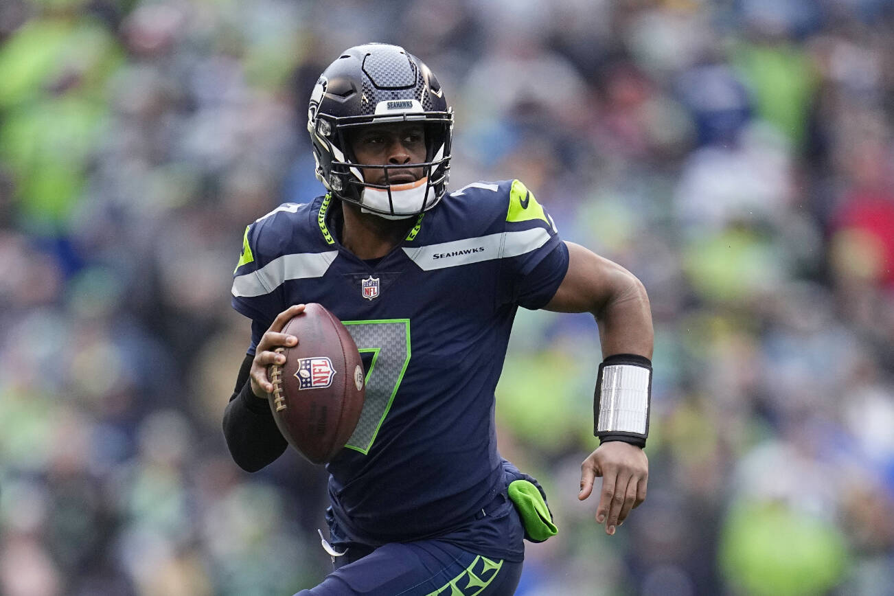 FILE - Seattle Seahawks quarterback Geno Smith (7) runs with the ball during the first half of the team's NFL football game against the Los Angeles Rams, Jan. 8, 2023, in Seattle. New York Giants running back Saquon Barkley, 49ers running back Christian McCaffrey and Smith are the finalists for AP Comeback Player of the Year. (AP Photo/Abbie Parr, File)