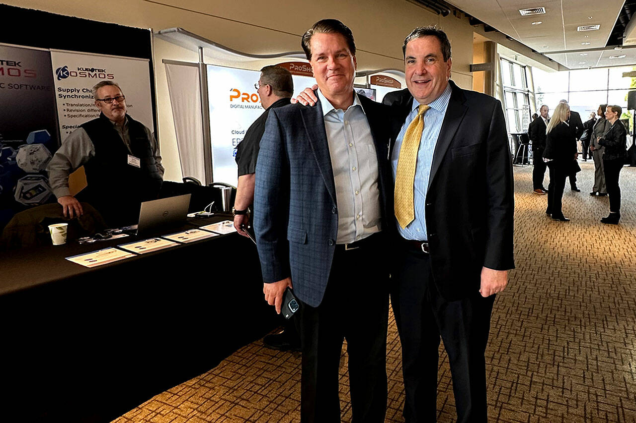 Kevin Michaels, left, and Richard Aboulafia, managing directors at AeroDynamic Advisory, an aerospace consulting firm, attend the Pacific Northwest Aerospace Alliance conference Wednesday at the Lynnwood Convention Center. (Janice Podsada / The Herald)