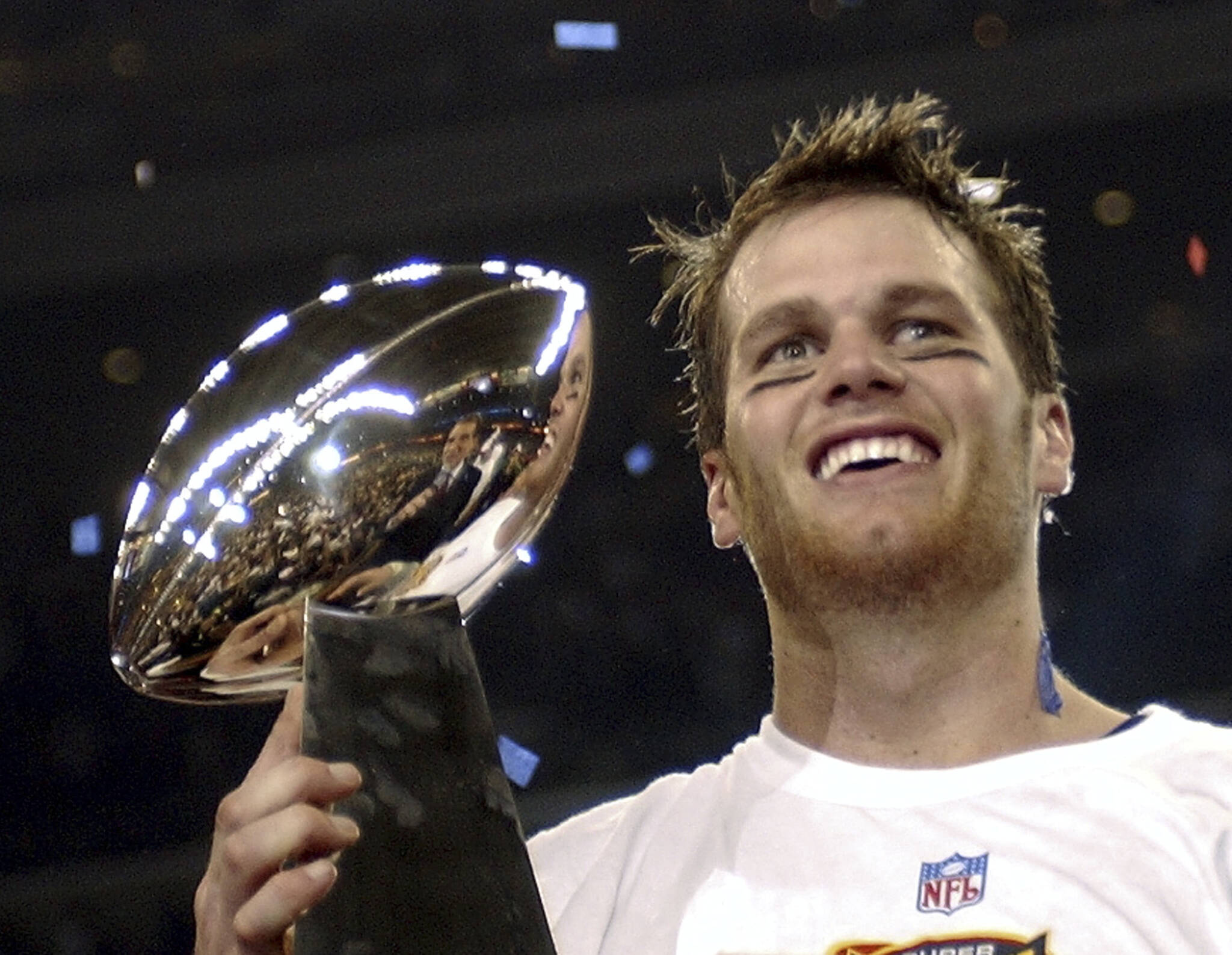 New England quarterback Tom Brady holds the Vince Lombardi Trophy after the Patriots beat the Carolina Panthers 32-29 in Super Bowl 38 on Feb. 1, 2004, in Houston. (AP Photo/Dave Martin)