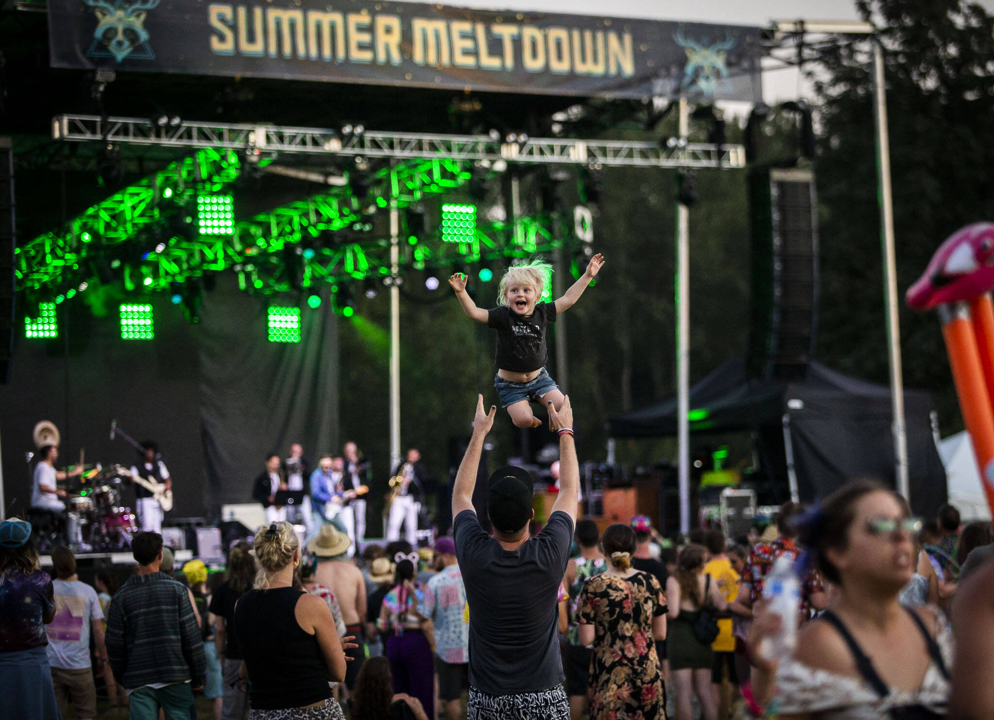 Tala Davey-Wraight, 3, is thrown in the air by her dad Oscar Davey-Wraight, one of the Summer Meltdown headliners also known as Opiuo, during Cory Wong’s set on July 28, 2022 in Snohomish. (Olivia Vanni / The Herald)