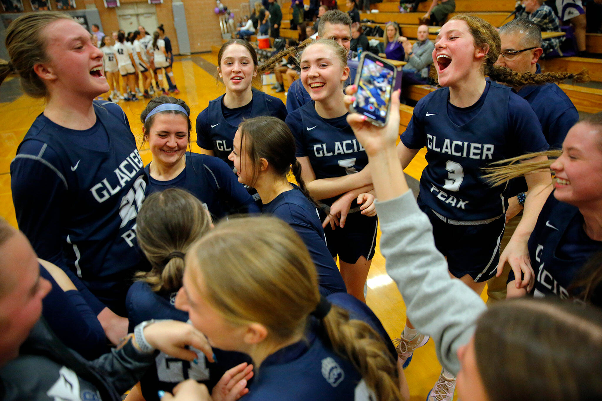 The Glacier Peak girls celebrate holding off a late run by Kamiak on Wednesday, Feb 1, 2023, at Kamiak High School in Mukilteo, Washington. (Ryan Berry / The Herald)