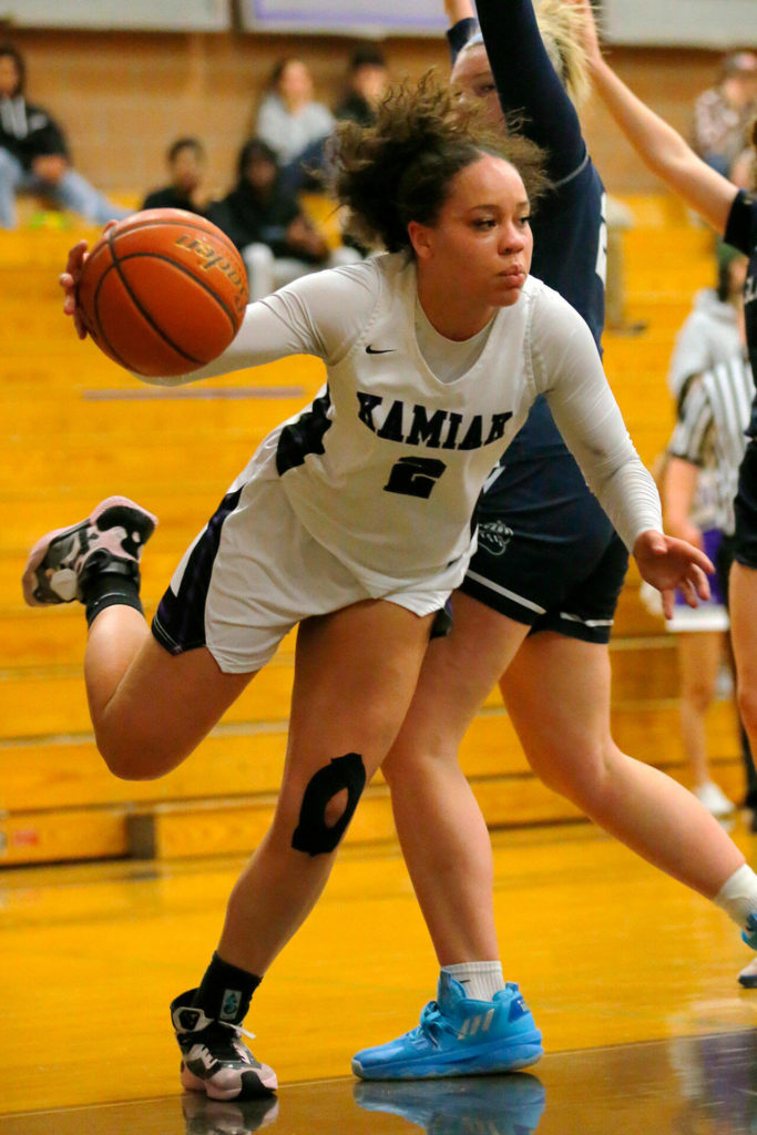 Kamiak’s Salem Bahta gets fouled under the basket against Glacier Peak on Wednesday, Feb 1, 2023, at Kamiak High School in Mukilteo, Washington. (Ryan Berry / The Herald)
