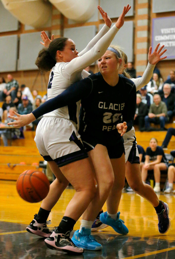 Glacier Peak’s Kate Fowler tries to pass out of tight defense after getting a rebound against Kamiak on Wednesday, Feb 1, 2023, at Kamiak High School in Mukilteo, Washington. (Ryan Berry / The Herald)
