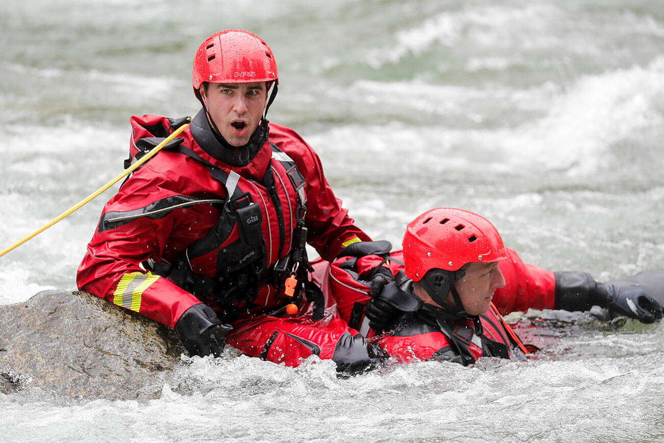 Firefighters works through rescue drills during the Snohomish Regional Fire & Rescue’s annual Water Rescue Academy on the Skykomish River Thursday afternoon in Index, Washington on May 5, 2022. (Kevin Clark / The Herald)