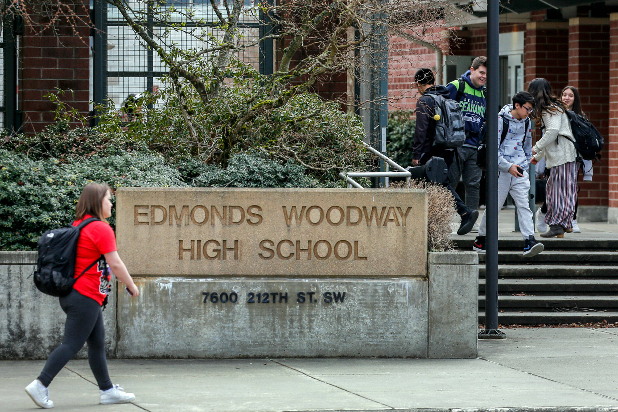 Students make their way after school at Edmonds-Woodway High School on March 12, 2020. All public and private schools in Snohomish, King and Pierce counties must close for six weeks. (Kevin Clark / The Herald)